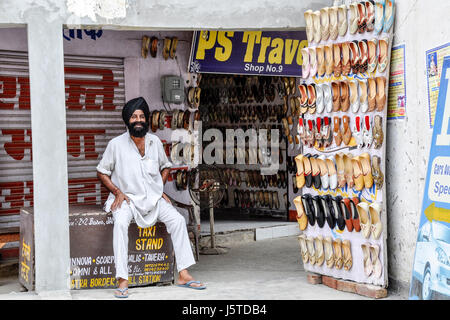 Amritsar, India, september 4, 2010: Indian sikh in his shop selling shoes in Amritsar in India. Stock Photo