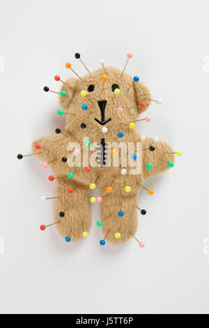 a quirky teddy bear like a voodoo doll isolated Stock Photo