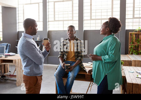 Three African office colleagues talking together during a coffee break Stock Photo