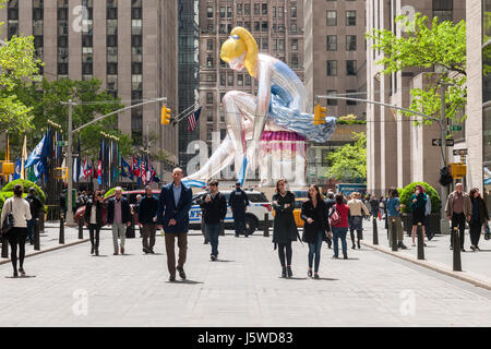 Visitors observe Jeff Koons' sculpture 'Seated Ballerina' unveiled in Rockefeller Plaza in New York on Friday, May 12, 2017. The 45-foot tall inflatable nylon sculpture is based on a small porcelain figurine. This is Koons' third installation in Rockefeller Plaza with 'Puppy' and 'Split-Rocker' being show in 2000 and 2014 respectively. The sculpture will be on view until June 2 and will be deflated during inclement weather. © Richard B. Levine) Stock Photo
