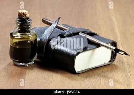 old fashioned diary with dib pen and inkwell on desktop Stock Photo