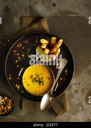 coconut pumpkin soup with spicy pumpkin seeds Stock Photo