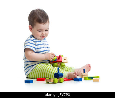 Baby boy playing with blocks toys. Isolated on white. Stock Photo