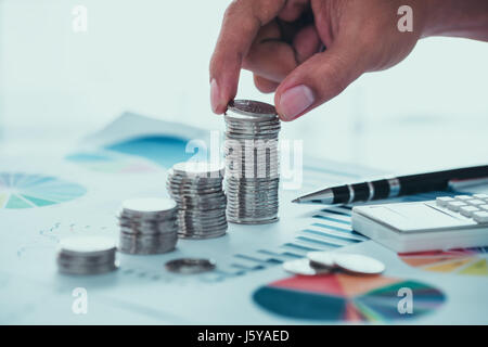 Business concept of saving money with coins and graph Stock Photo