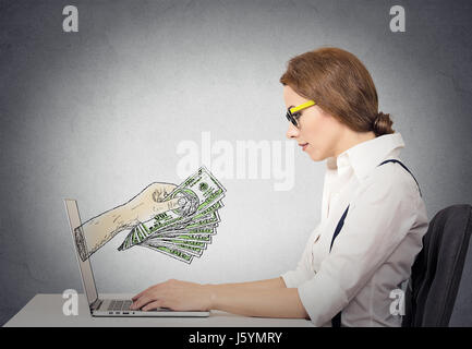 business woman with glasses working online on computer making earning money, hand with dollar bills banknotes coming out of laptop screen, isolated gr Stock Photo