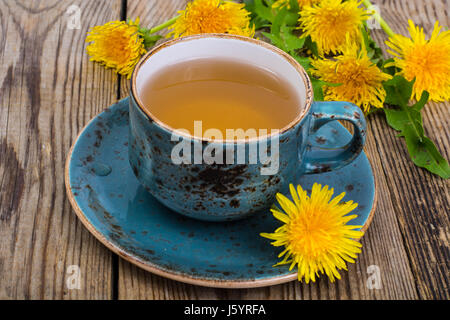 Hot tea and fragrant honey from dandelions in a blue vintage cup. Studio Photo Stock Photo