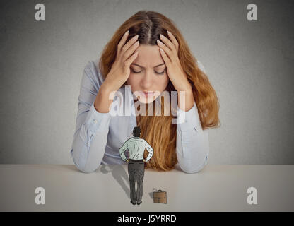 Desperate stressed business woman leaning on a desk small bossy executive man patronizing her. Negative human emotions face expression feelings life p Stock Photo