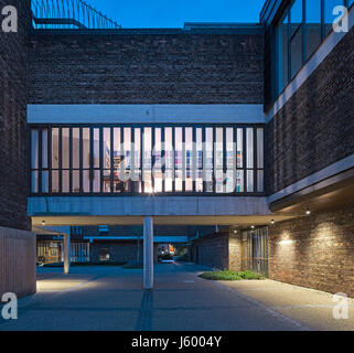 Exterior view within courtyard at dusk. Baylis Old school, London, United Kingdom. Architect: Conran and Partners, 1960. Stock Photo