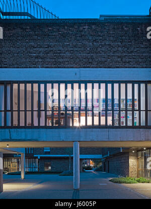 Exterior view within courtyard at dusk. Baylis Old school, London, United Kingdom. Architect: Conran and Partners, 1960. Stock Photo