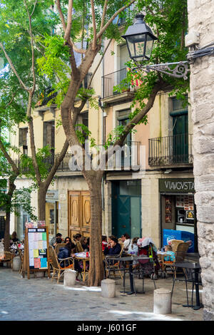 Diners eating al fresco style in the old quarter of Girona, Spain.