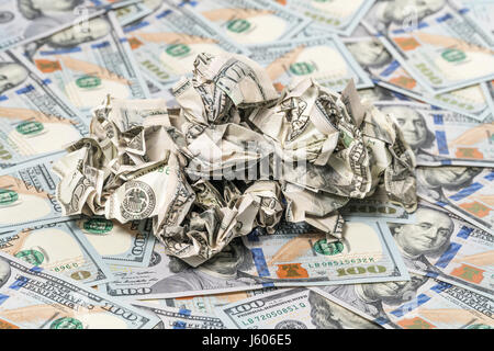 Pile of crumpled money on a background of hundred-dollar bills Stock Photo