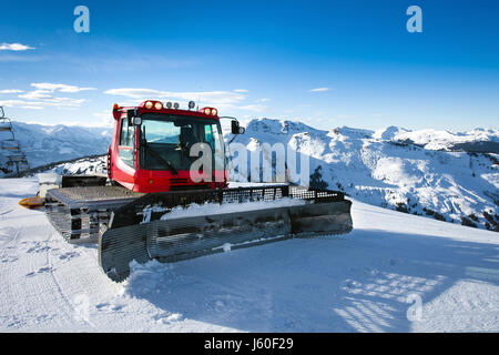 Snow-grooming machine on snow hill ready for skiing slope preparations in Austrian Alps. Stock Photo