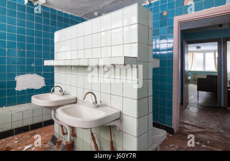 Bathroom with wash hand basin in the abandoned building of the children's pioneer camp Stock Photo