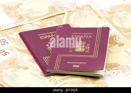 Spanish passport with european union currency banknotes as a background Stock Photo