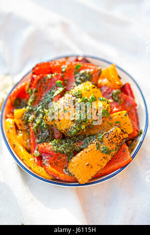Antipasti - red, green and red peppers with green pesto Stock Photo