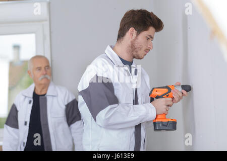 Young tradesman using cordless drill Stock Photo