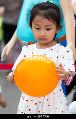 Chinese girl with balloon, Yinchuan, Ningxia, China Stock Photo