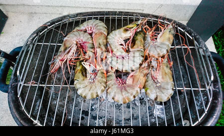 Large fresh royal prawns on the grill. Studio Photo Stock Photo