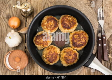 Tasty fried chops in frying pan. Studio Photo Stock Photo