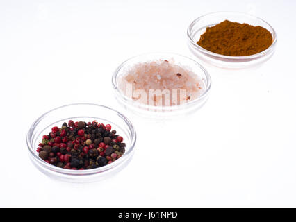 Salt, black pepper and curry in glass isolated on white background. Studio Photo Stock Photo