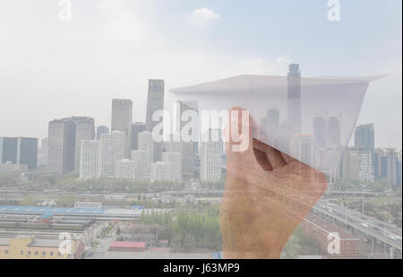 Hand throwing a paper plane, double exposure concept Stock Photo