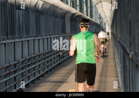 MONTREAL, CA - 18 May 2017: Runner and Cyclist on Jacques-Cartier Bridge's multipurpose path Stock Photo