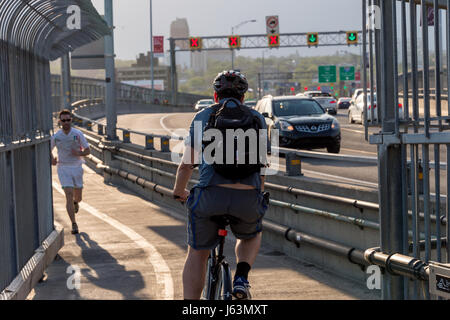 MONTREAL, CA - 18 May 2017: Runner and Cyclist on Jacques-Cartier Bridge's multipurpose path Stock Photo