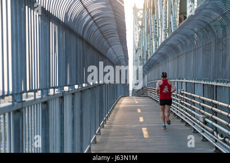 MONTREAL, CA - 18 May 2017. Man running on Jacques-Cartier Bridge's multipurpose path Stock Photo