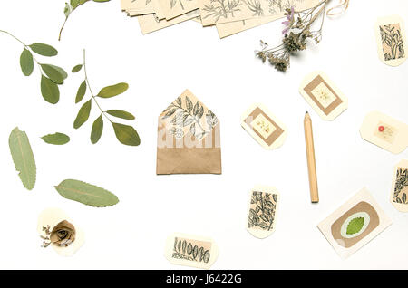 Handmade labels and pressed flowers. Working desk of crafter Stock Photo