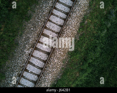 Aerial view of railway track through countryside, drone top view pov of rails as abstract background Stock Photo