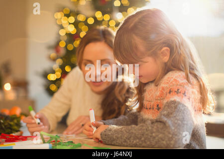 Mother and daughter making Christmas decorations Stock Photo