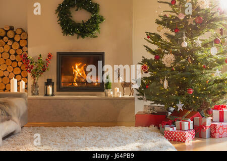 Ambient fireplace and Christmas tree in living room Stock Photo