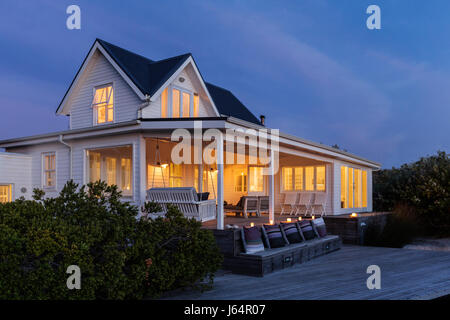 Illuminated white home showcase exterior at night Stock Photo