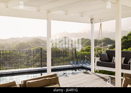 Sunny modern home showcase patio Stock Photo