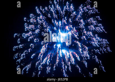 Colourful trails of light left by exploding fireworks in the night sky. Stock Photo