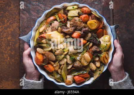 Woman holding her hands ready dish with kasul Stock Photo