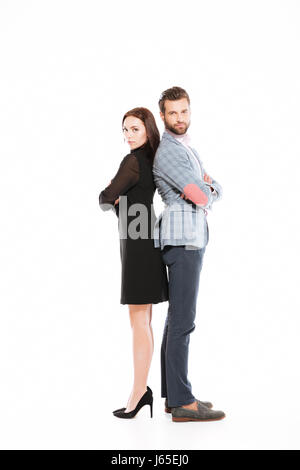 Image of young offended loving couple standing isolated over white background. Looking at camera. Stock Photo