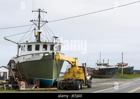 Crane by fishing trawler at harbor, Marie Joseph, Nova Scotia, Canada Stock Photo