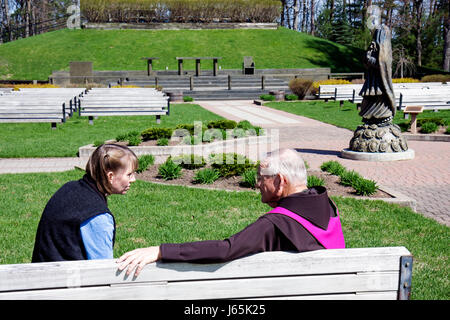 Michigan Indian River,National Shrine of the Cross in the Woods,Catholic church,shrine outdoor sanctuary,confession man woman female Franciscan priest Stock Photo