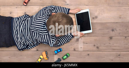 top view header of boy playing with tablet pc Stock Photo