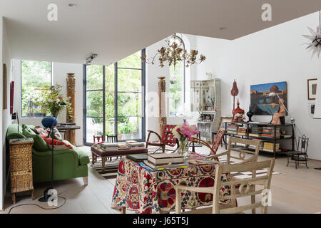 Triple-height living space with rare wooden Austrian columns, books and old textiles Stock Photo