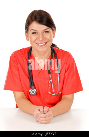 Beautiful happy female doctor wearing red lab coat posing on isolated background Stock Photo