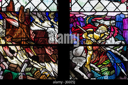 The conquest of evil depicted in the First World War memorial window by Christopher Whall, St. Peter's Church, Norton on Derwent, North Yorkshire, UK. Stock Photo