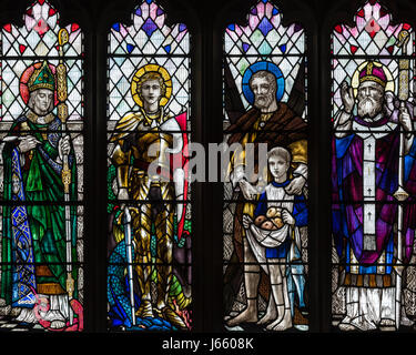 The four British Patron Saints in the First World War Memorial window by Christopher Whall, St. Peter's Church, Norton on Derwent, North Yorkshire, UK Stock Photo