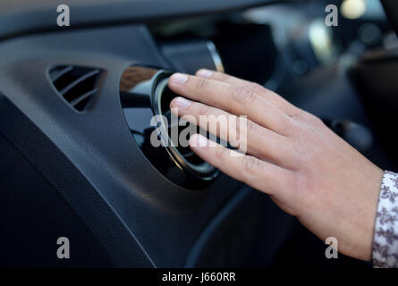 Driver hand on air ventilation grille with power regulator, checking the air from air ventilation in the car Stock Photo