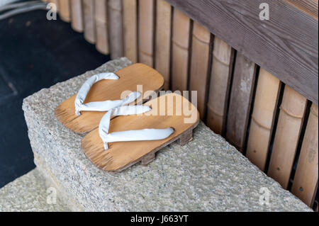 Geta or traditional Japanese footwear, a kind of flip-flops or sandal with an elevated wooden base held onto the foot with a fabric thong strap Stock Photo