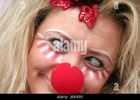 costumed woman with red nose Stock Photo