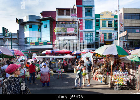 Colorful umbrellas shade buyers and sellers at the Baclaran open-air market in Manila, Philippines. Stock Photo