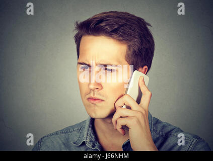 Serious sad man having mobile phone conversation Stock Photo