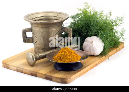 Still Life Spices, Immortin saffron ,marigold staminas in a copper vase on a wooden board on a background of a stern stupa for grinding spices, bunche Stock Photo